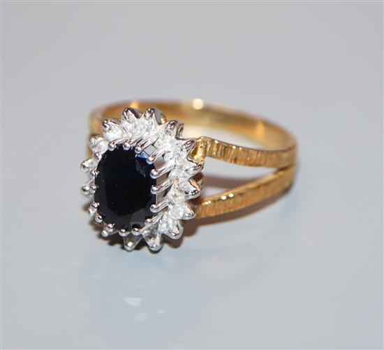 A modern 18ct gold, sapphire and diamond oval cluster ring, size S